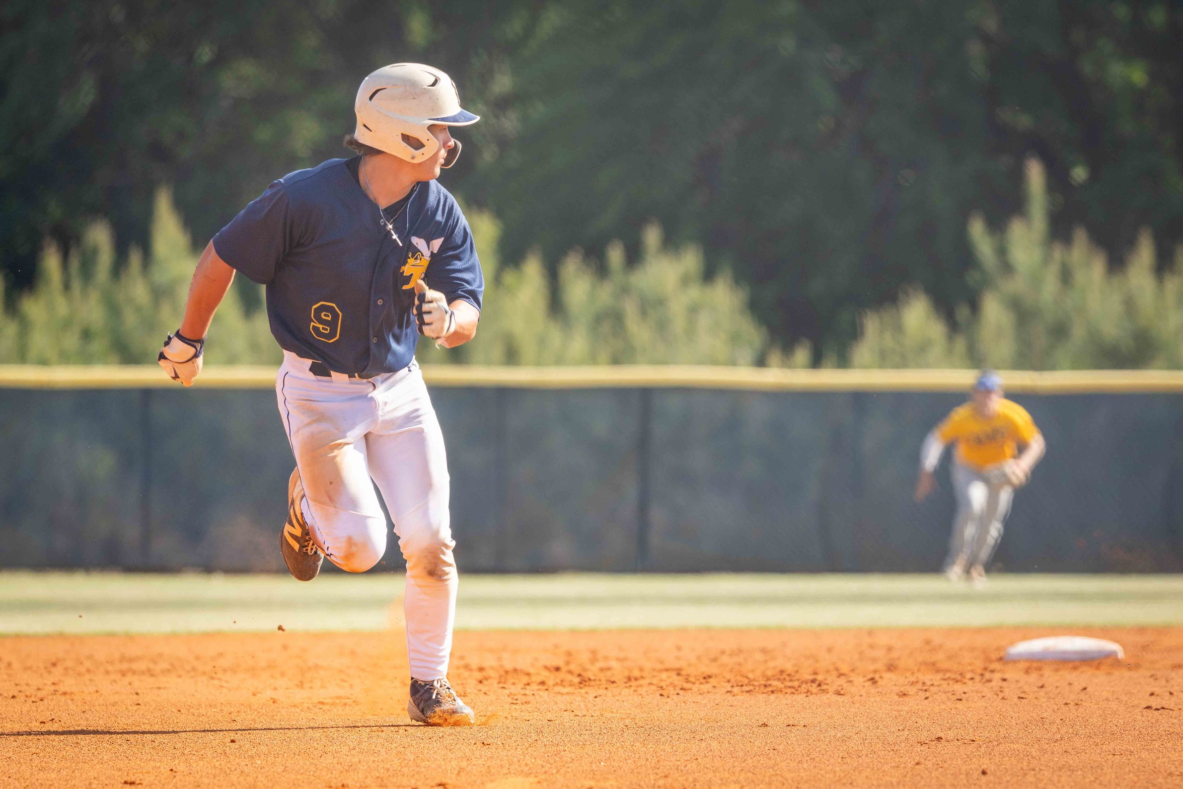 Jake Zehner is seen running from second base to third base.