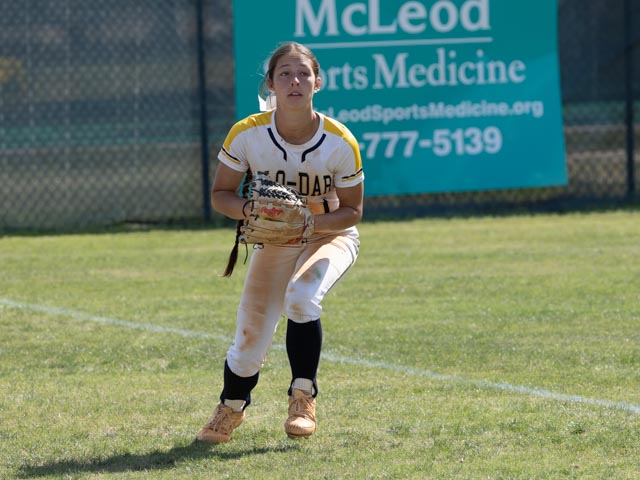 Keira Bell is seen fielding the ball in the outfield.